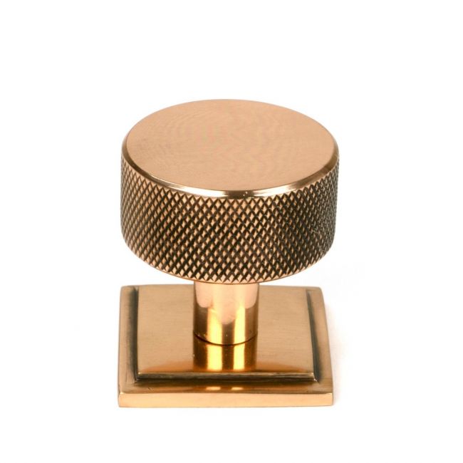 The 32mm Knurled Cabinet Knob on Square Rose in Polished Bronze Shown Upright on a White Background The 32mm Knurled Cabinet Knob on Square Rose in Polished Bronze Shown Upright on a White Background
