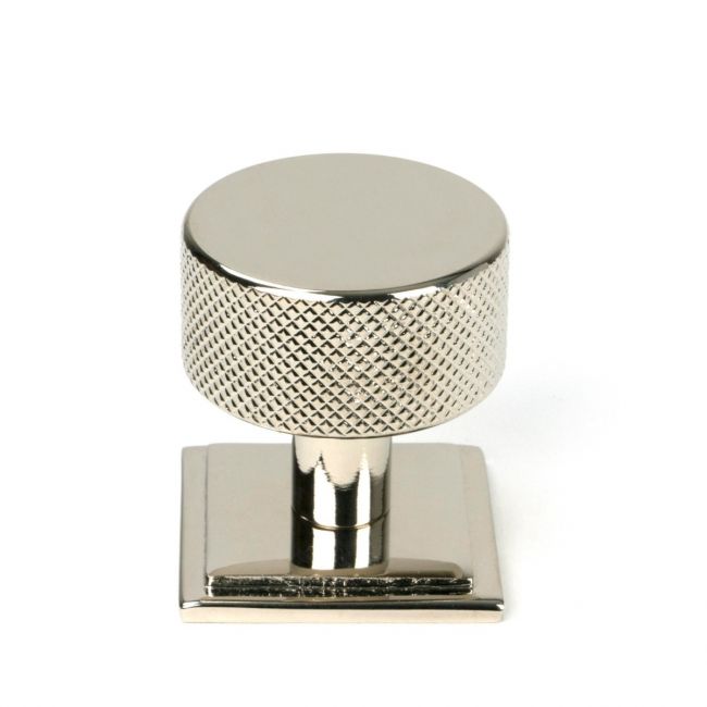 The 32mm Knurled Cabinet Knob on Square Rose in Polished Nickel Shown Upright on a White Background