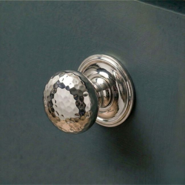 The 32mm Polished Nickel Hammered Mushroom Cabinet Knob Mounted on a Blue Kitchen Cabinet - Digital Illustration 