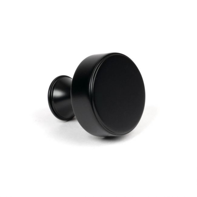 The 38mm "Atelier" Circular Cabinet Knob in Matt Black on a White Background Shown Side On 