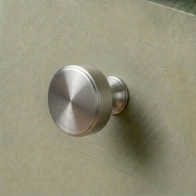 The 38mm "Atelier" Circular Cabinet Knob in Satin Chrome Designed for Kitchen Cupboards Mounted on a Mint Green Drawer - Digital Illustration