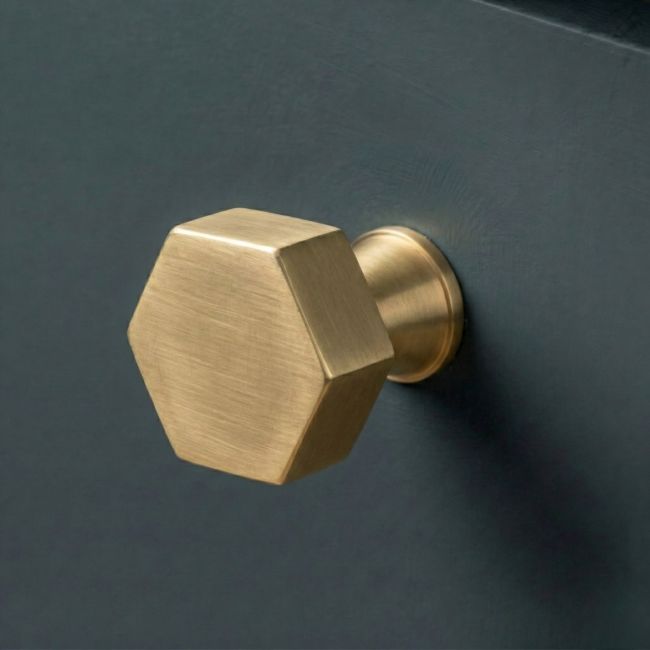 The 38mm "Vanguard" Hexagonal Cabinet Knob in Aged Brass Fitted on a Blue Cupboard Perfect for Kitchen Drawers - Digital Illustration The 38mm "Vanguard" Hexagonal Cabinet Knob in Aged Brass Fitted on a Blue Cupboard Perfect for Kitchen Drawers - Digital Illustration