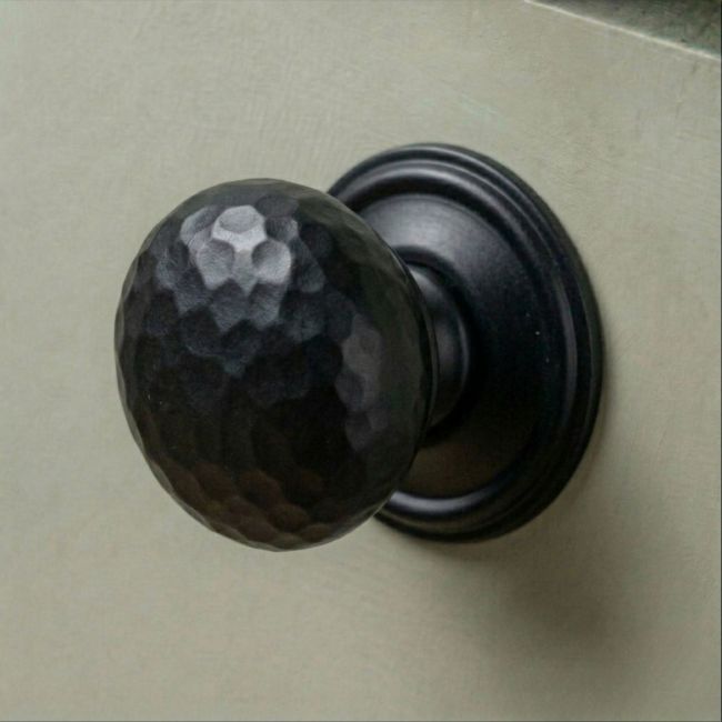 The 38mm Aged Copper Hammered Mushroom Cabinet Knob Mounted on a Sage Green Kitchen Cabinet - Digital Illustration
