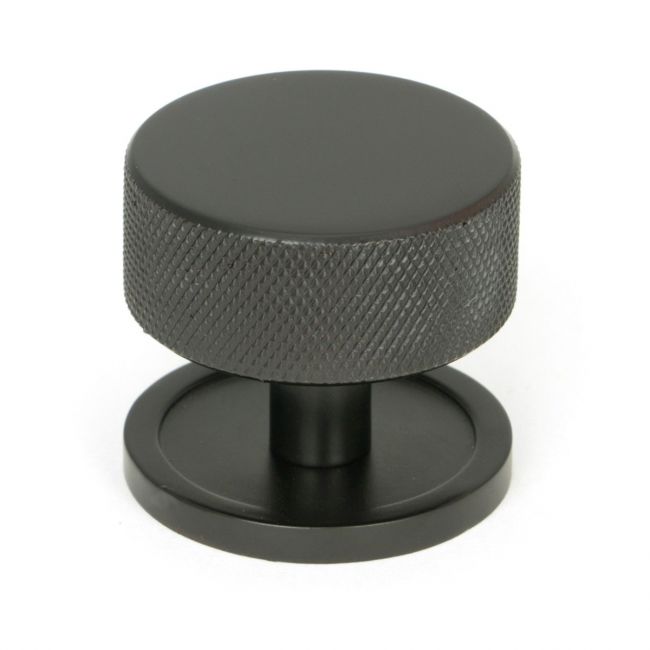 The 38mm Knurled Cabinet Knob on a Plain Rose in Aged Bronze Shown Upright on a White Background