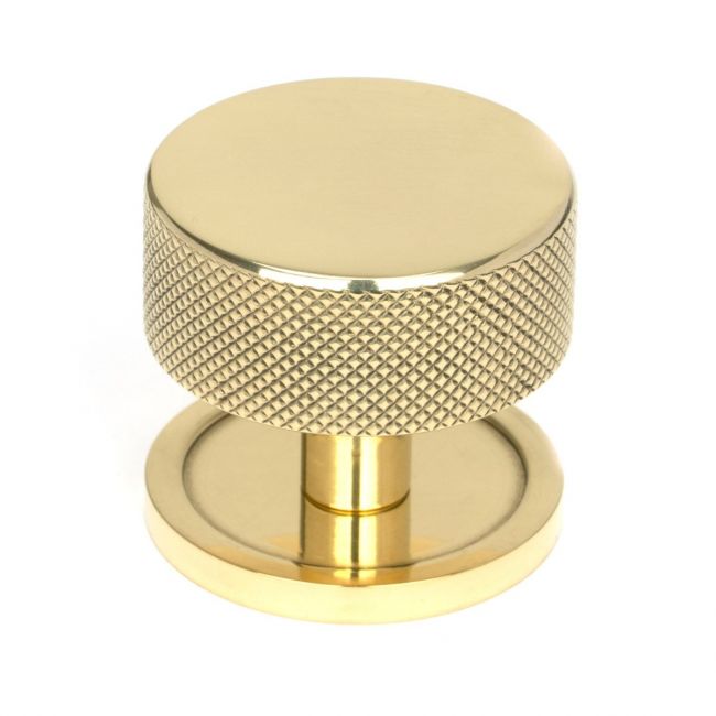 The 38mm Knurled Cabinet Knob on a Plain Rose in Polished Brass Shown Upright on a White Background The 38mm Knurled Cabinet Knob on a Plain Rose in Polished Brass Shown Upright on a White Background