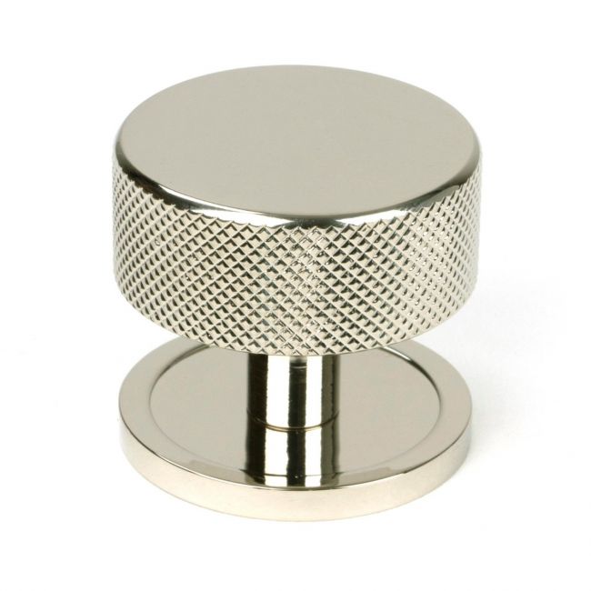 The 38mm Knurled Cabinet Knob on a Plain Rose in Polished Nickel Shown Upright on a White Background