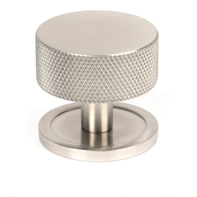 The 38mm Knurled Cabinet Knob on a Plain Rose in Satin Stainless Steel Shown Upright on a White Background
