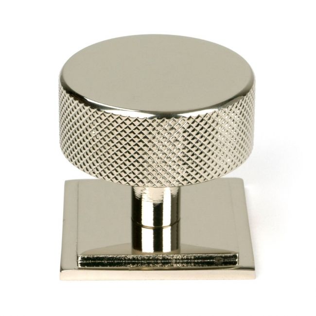 The 38mm Knurled Cabinet Knob on a Square Rose in Polished Nickel Shown Upright on a White Background