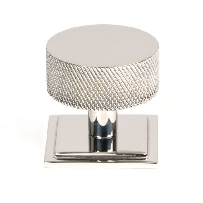 The 38mm Knurled Cabinet Knob on a Square Rose in Polished Stainless Steel Shown Upright on a White Background
