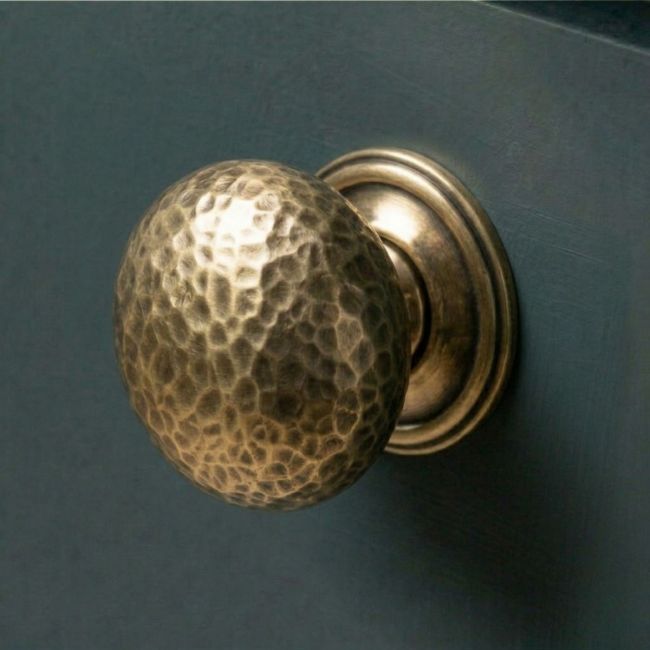 The 38mm Polished Copper Hammered Mushroom Cabinet Knob on a Contemporary Blue Kitchen Cupboard - Digital Illustration