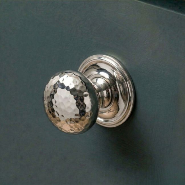 The 38mm Polished Nickel Hammered Mushroom Cabinet Knob Mounted on a Blue Kitchen Cabinet - Digital Illustration 
