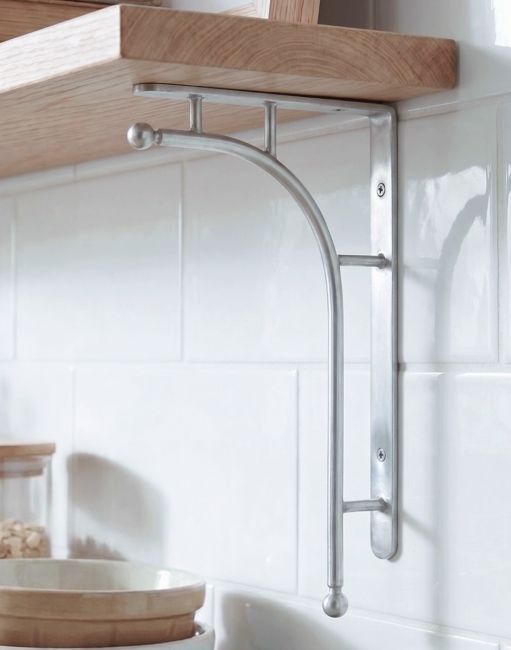 The 50 x 24cm ’Kepler’ Polished Aluminium Modern Wall Bracket Mounted on a White Tiled Kitchen Wall in a Modern Home - Digital Illustration 