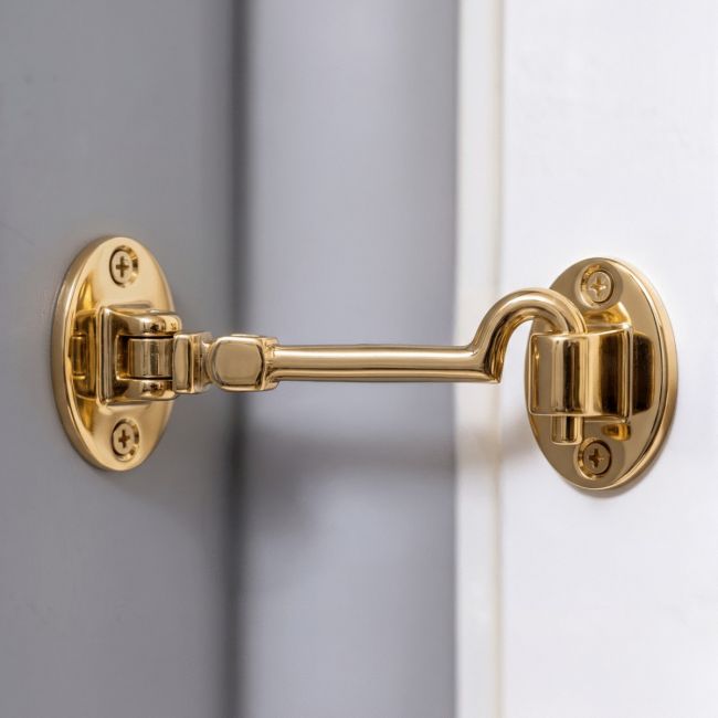 The 6 Inch Brass Cabin Hook Silent Type on a Grey Internal Wall Holding Open a White Door - Digital Illustration The 6 Inch Brass Cabin Hook Silent Type on a Grey Internal Wall Holding Open a White Door - Digital Illustration