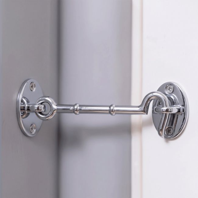 The 6 Inch Bright Chrome Cabin Hooks Loose Ring Type on a Grey Wall in a Contemporary Home - Digital Illustration  