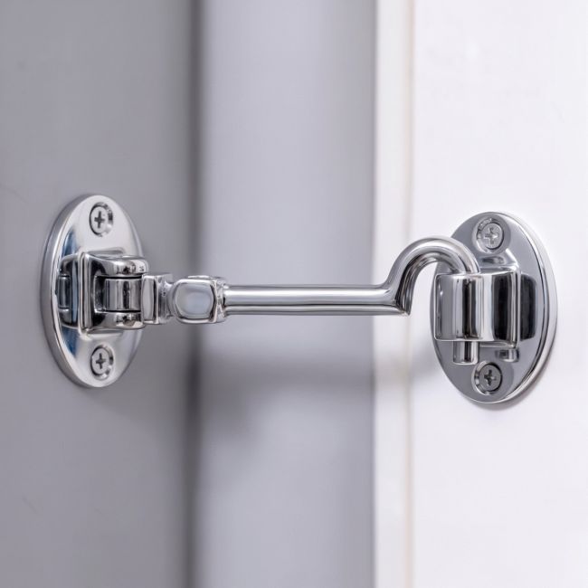 The 6 Inch Bright Chrome Cabin Hooks Silent Type Mounted on a Grey Wall to Prop Open a Door - Digital Illustration The 6 Inch Bright Chrome Cabin Hooks Silent Type Mounted on a Grey Wall to Prop Open a Door - Digital Illustration