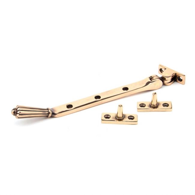 The 8 Inch Polished Bronze Georgian Reeded Casement Window Stay on a White Background The 8 Inch Polished Bronze Georgian Reeded Casement Window Stay on a White Background