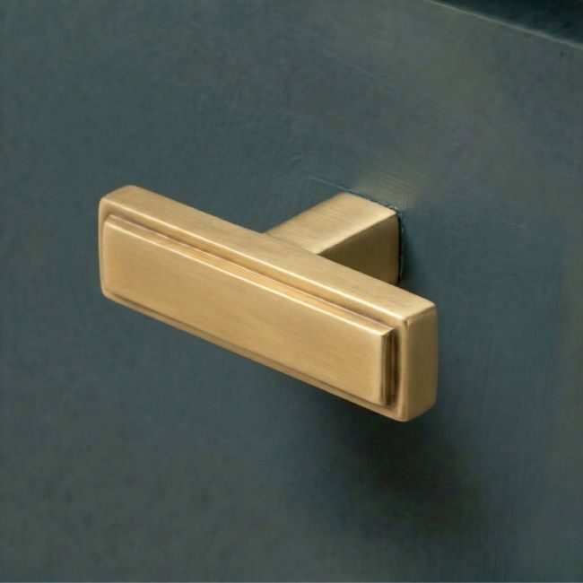 The "Emerson" Rectangular T-Bar Cabinet Pull Handle in an Aged Brass Finish on a White Background Shown at an Angle The "Emerson" Rectangular T-Bar Cabinet Pull Handle in an Aged Brass Finish on a White Background Shown at an Angle