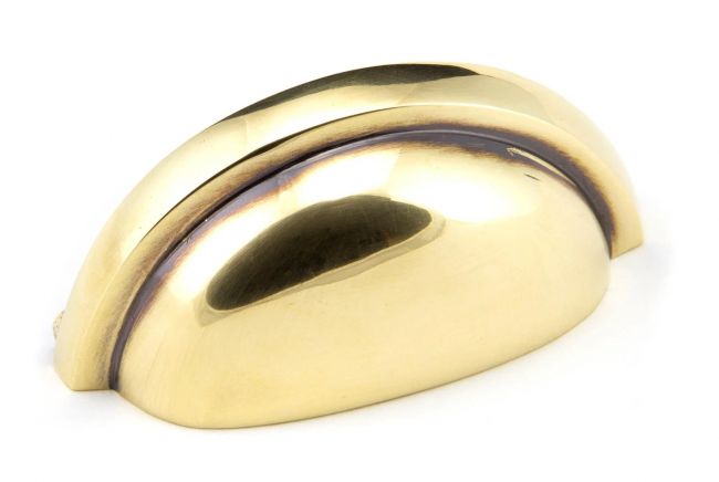 The Aged Brass Finish Cup Pull Handle on a White Background
