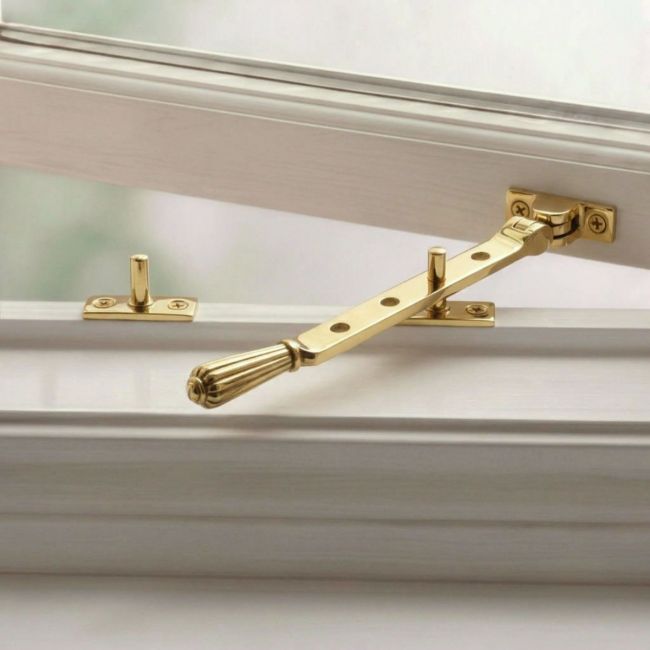 The 8 Inch Aged Brass Georgian Reeded Casement Window Stay on a White Background 