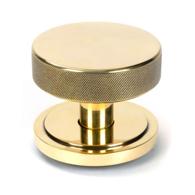The Aged Brass Knurled Centre Door Knob on Art Deco Rose Shown Upright on a White Background The Aged Brass Knurled Centre Door Knob on Art Deco Rose Shown Upright on a White Background