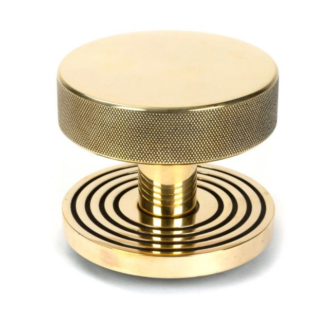 The Aged Brass Knurled Centre Door Knob on Beehive Rose Shown Upright on a White Background The Aged Brass Knurled Centre Door Knob on Beehive Rose Shown Upright on a White Background