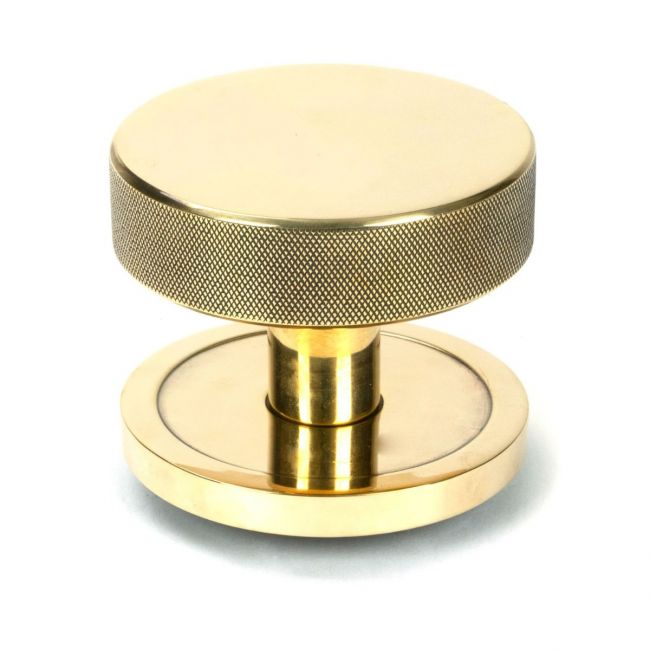 The Aged Brass Knurled Centre Door Knob on Plain Rose Shown Upright on a White Background The Aged Brass Knurled Centre Door Knob on Plain Rose Shown Upright on a White Background
