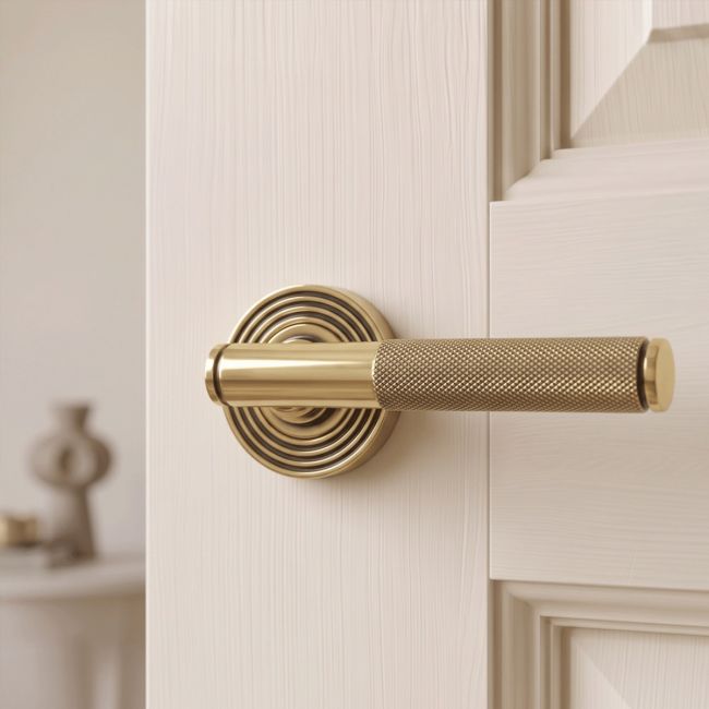 The Aged Brass Knurled Lever on Beehive Rose Set on a White Background 