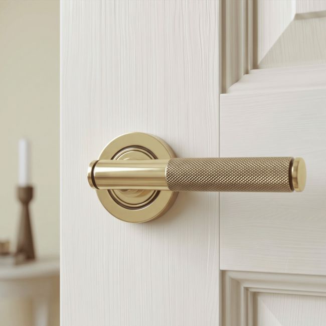 The Aged Brass Knurled Lever on Plain Rose Set on a White Background 