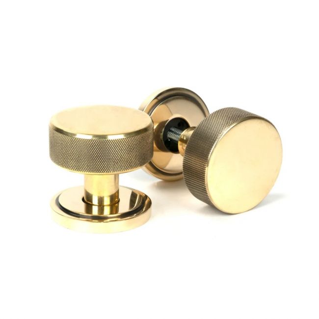 The Aged Brass Knurled Mortice/Rim Knob Set on an Art Deco Rose Shown Upright and on its Side The Aged Brass Knurled Mortice/Rim Knob Set on an Art Deco Rose Shown Upright and on its Side