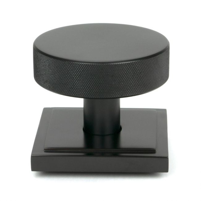 The Aged Bronze Knurled Centre Door Knob on a Square Rose Shown Upright on a White Background The Aged Bronze Knurled Centre Door Knob on a Square Rose Shown Upright on a White Background