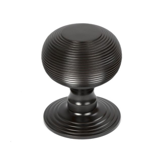 The Aged Bronze Traditional Beehive Centre Door Knob Shown Upright on a White Background 