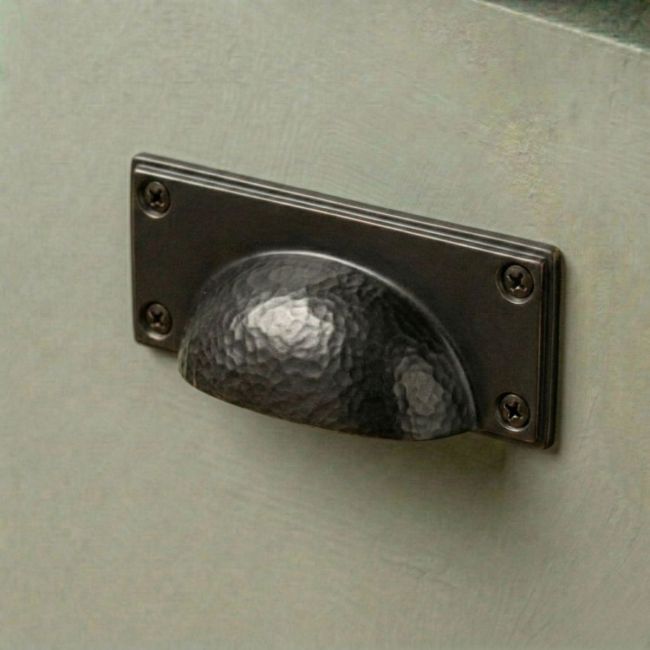 The Aged Copper Rectangular Drawer Pull with Curved Hammered Handle Mounted on a Green Kitchen Cupboard in a Contemporary Home - Digital Illustration The Aged Copper Rectangular Drawer Pull with Curved Hammered Handle Mounted on a Green Kitchen Cupboard in a Contemporary Home - Digital Illustration