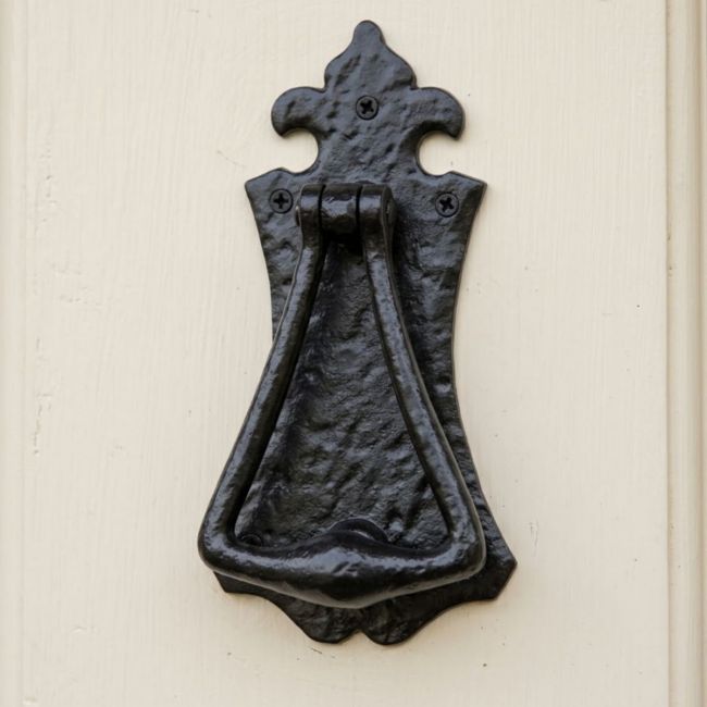 The Antique Black Iron Gothic Style Fleur De Lys Door Knocker on a Cream Coloured Front Door to a Country Cottage - Digital Illustration