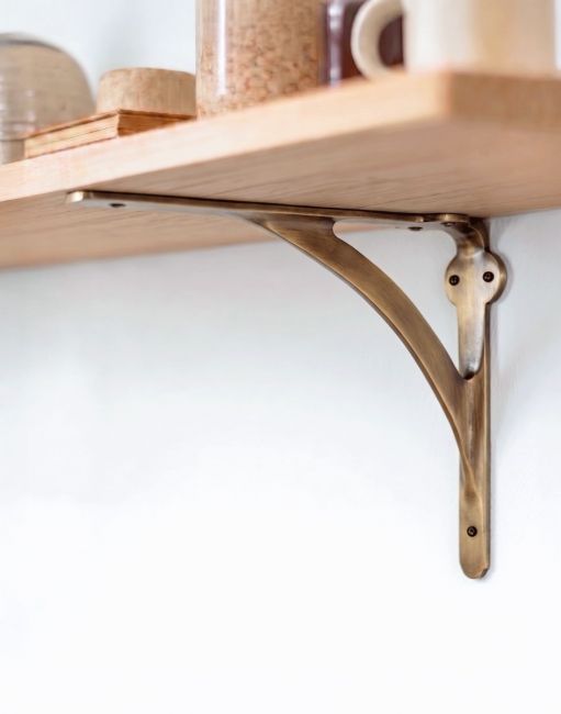 The Antique Brass Stylish Architectural Shelf Bracket USed as a Decorative Wall Hanger on a Wooden Shelf - Digital Illustration