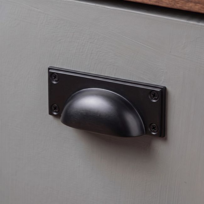 The Art Deco Cup Drawer Pull with Backplate in Aged Bronze on a White Background 