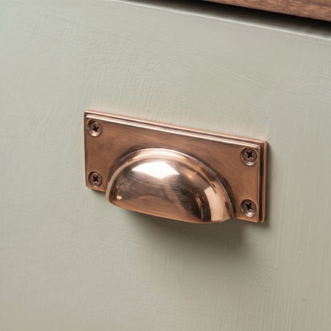 The Art Deco Cup Drawer Pull with Backplate in Polished Bronze on a White Background 