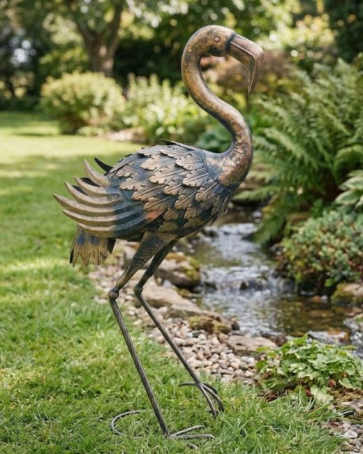 the Barnaby the Antique Gold Flamingo Garden Sculpture next to a Stream in a Country Garden - Digital Illustration 