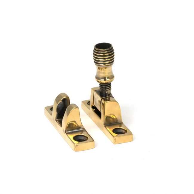 The Beehive Brighton Sash Square Window Fastener - Aged Brass on a White Background 