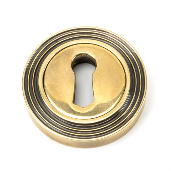 The Beehive Concealed Standard Keyhole Escutcheon - Aged Brass on a White Background The Beehive Concealed Standard Keyhole Escutcheon - Aged Brass on a White Background