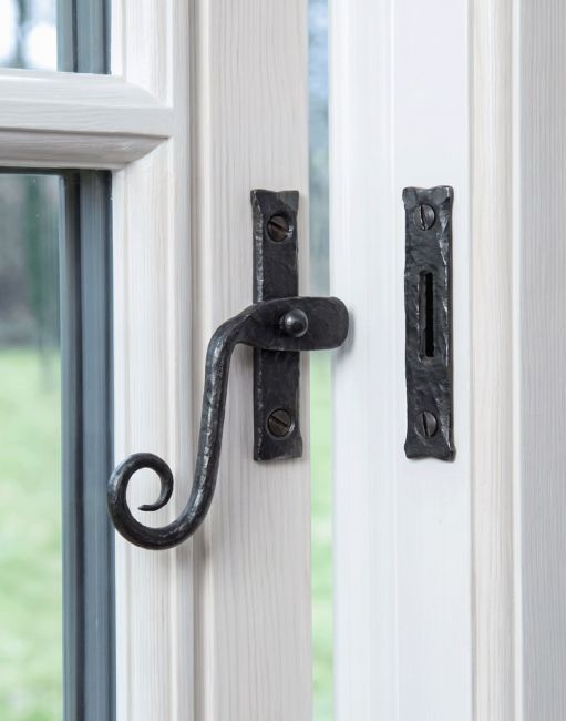The Bees Wax Monkey Tail Window Fastener Fitted on a White Painted Window Frame - Digital Illustration