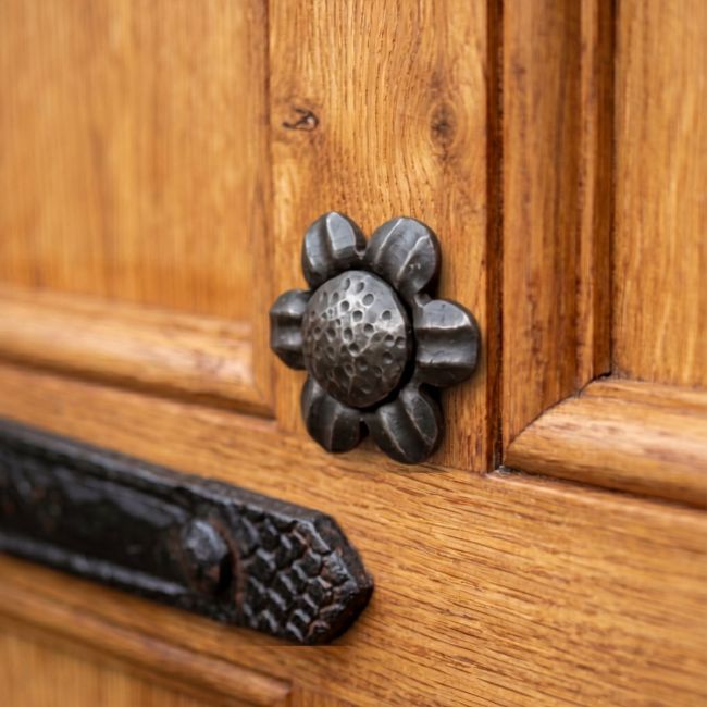 The Beeswax Daisy Door Stud Fitted on a Wooden Door - Digital Illustration