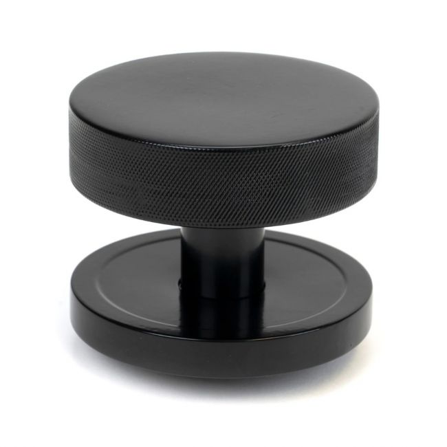 The Black Knurled Centre Door Knob on a Plain Rose Shown Upright on a White Background The Black Knurled Centre Door Knob on a Plain Rose Shown Upright on a White Background