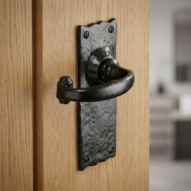Black Antique Wide Backplate Door Handles - Rustic Scalloped Lever Latch Pair on a White Background 
