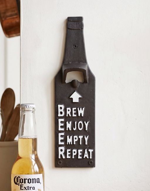The Bottle-Shaped Cast Iron Bottle Opener with the Message Brew Enjoy Empty Repeat Mounted on a Wall next to a Beer - Digital Illustration The Bottle-Shaped Cast Iron Bottle Opener with the Message Brew Enjoy Empty Repeat Mounted on a Wall next to a Beer - Digital Illustration