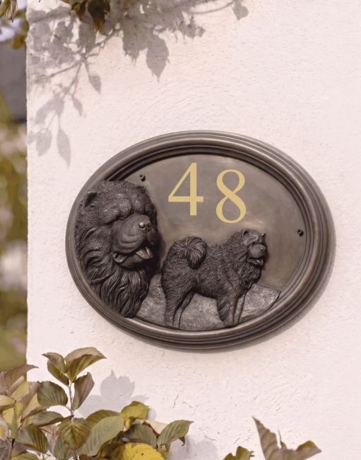 A Number 48 Chow Chow House Number Sign in a Bronze Finish Mounted on a Cream Coloured Cottage Wall - Digital Illustration A Number 48 Chow Chow House Number Sign in a Bronze Finish Mounted on a Cream Coloured Cottage Wall - Digital Illustration