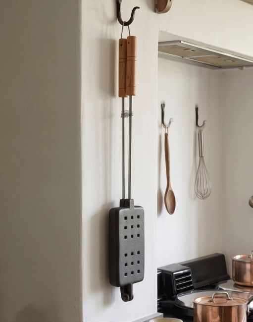 The Cast Iron “Charlwood” Waffle Iron Hung up in a Traditional Country Kitchen - Digital Illustration The Cast Iron “Charlwood” Waffle Iron Hung up in a Traditional Country Kitchen - Digital Illustration