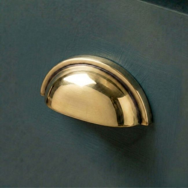 The Concealed Drawer Cup Pull Handle in an Aged Brass Finish Fitted on a Blue Kitchen Cupboard Drawer - Digital Illustration The Concealed Drawer Cup Pull Handle in an Aged Brass Finish Fitted on a Blue Kitchen Cupboard Drawer - Digital Illustration
