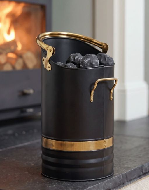 The Contemporary Black Coal Hod With Brass Handles in Front of a Sleek Black Fireplace - Digital Illustration The Contemporary Black Coal Hod With Brass Handles in Front of a Sleek Black Fireplace - Digital Illustration