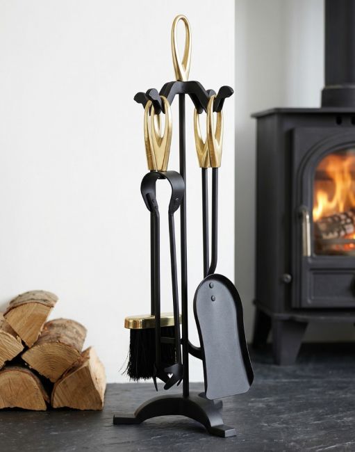The Contemporary Loop Handle Companion Set in Black With Brass Handles on a Black Stone Hearth with a Log Burner Stove - Digital Illustration 