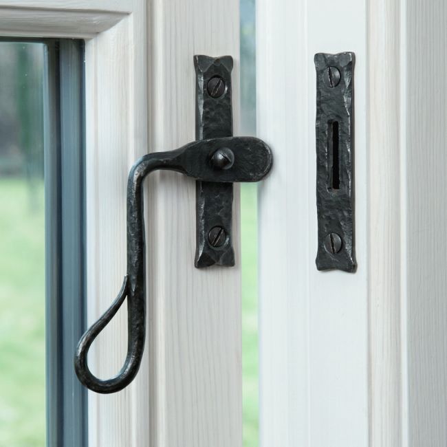 The Curved Shepherds Crook Bees Wax Window Fastener Fitted on a White Painted Window Frame - Digital Illustration